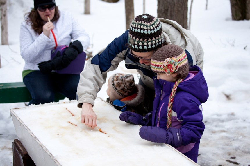 Rolling taffy onto a popsicle stick